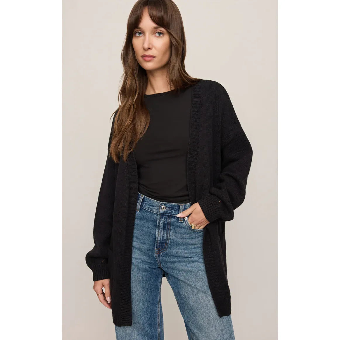 Z Supply Sanborn Cardigan in black on a model, oversized knit with ribbed trim and large patch pockets.