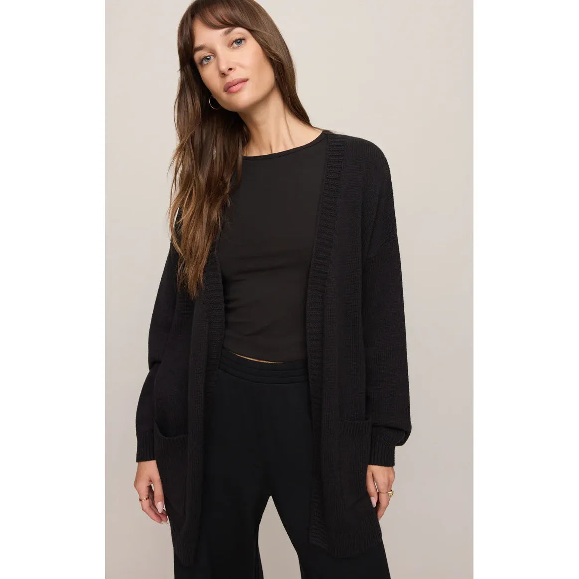 Z Supply Sanborn Cardigan on a model, black oversized knit with ribbed trim and oversized patch pockets.