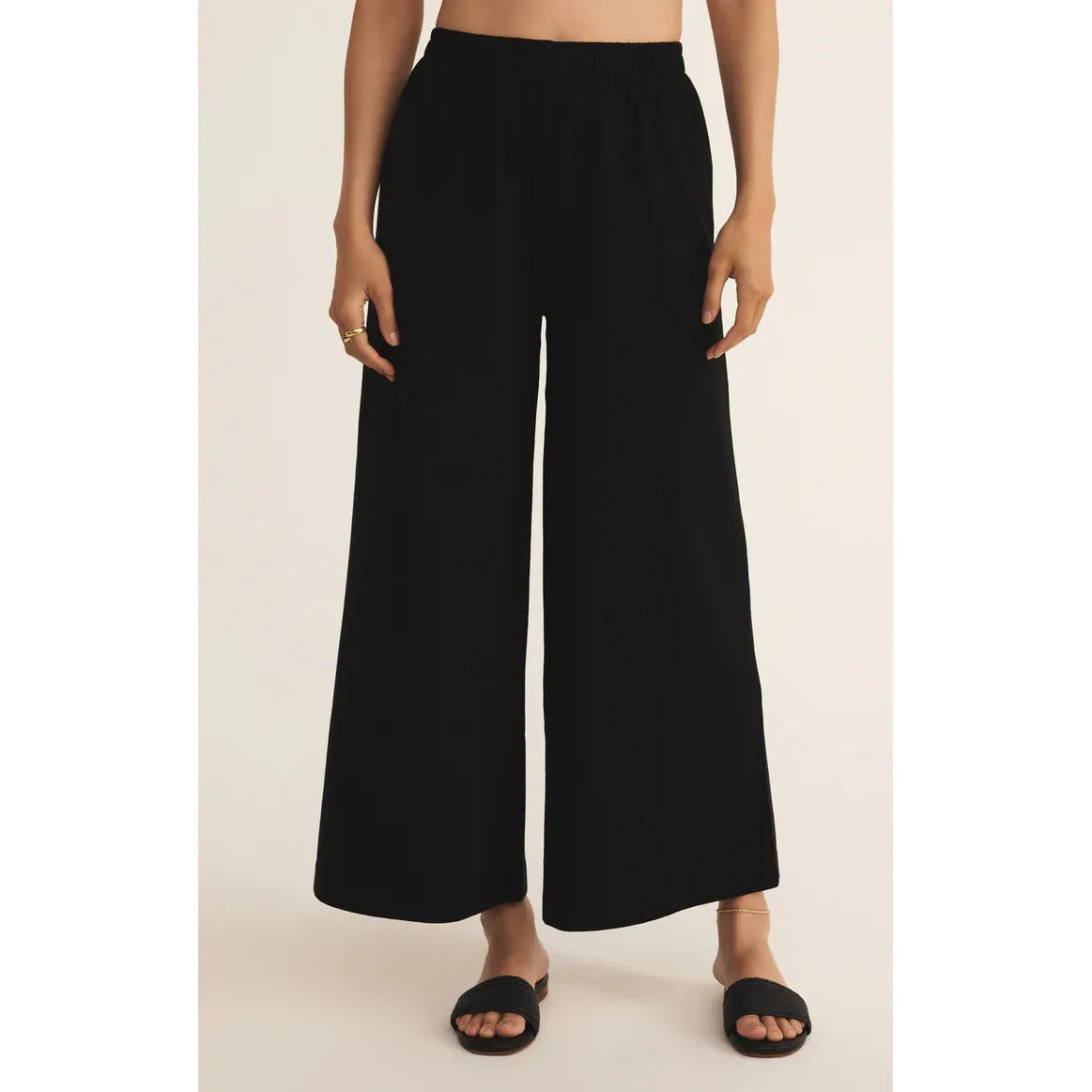 Black Z Supply Scout Jersey Flare Pant with elastic waist and wide-leg silhouette on model.