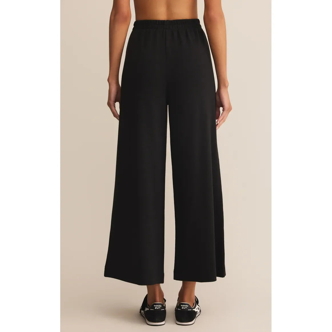 Back view of black Z Supply Scout Luxe Pant: high-rise, ribbed knit, ankle-length wide-leg, relaxed fit.