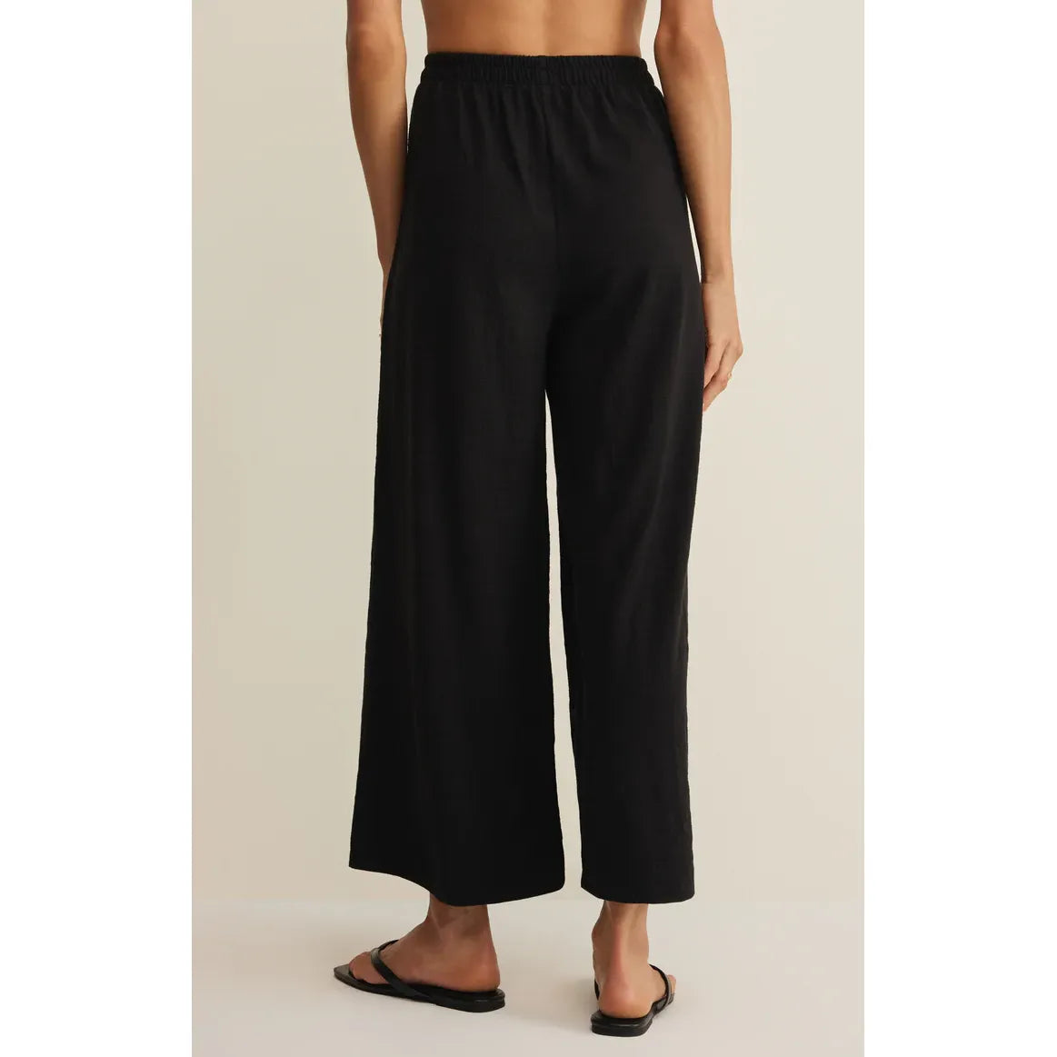 Z Supply Scout Textured Slub Pant in black, high-rise with elastic waistband, ankle-length wide-leg back view.