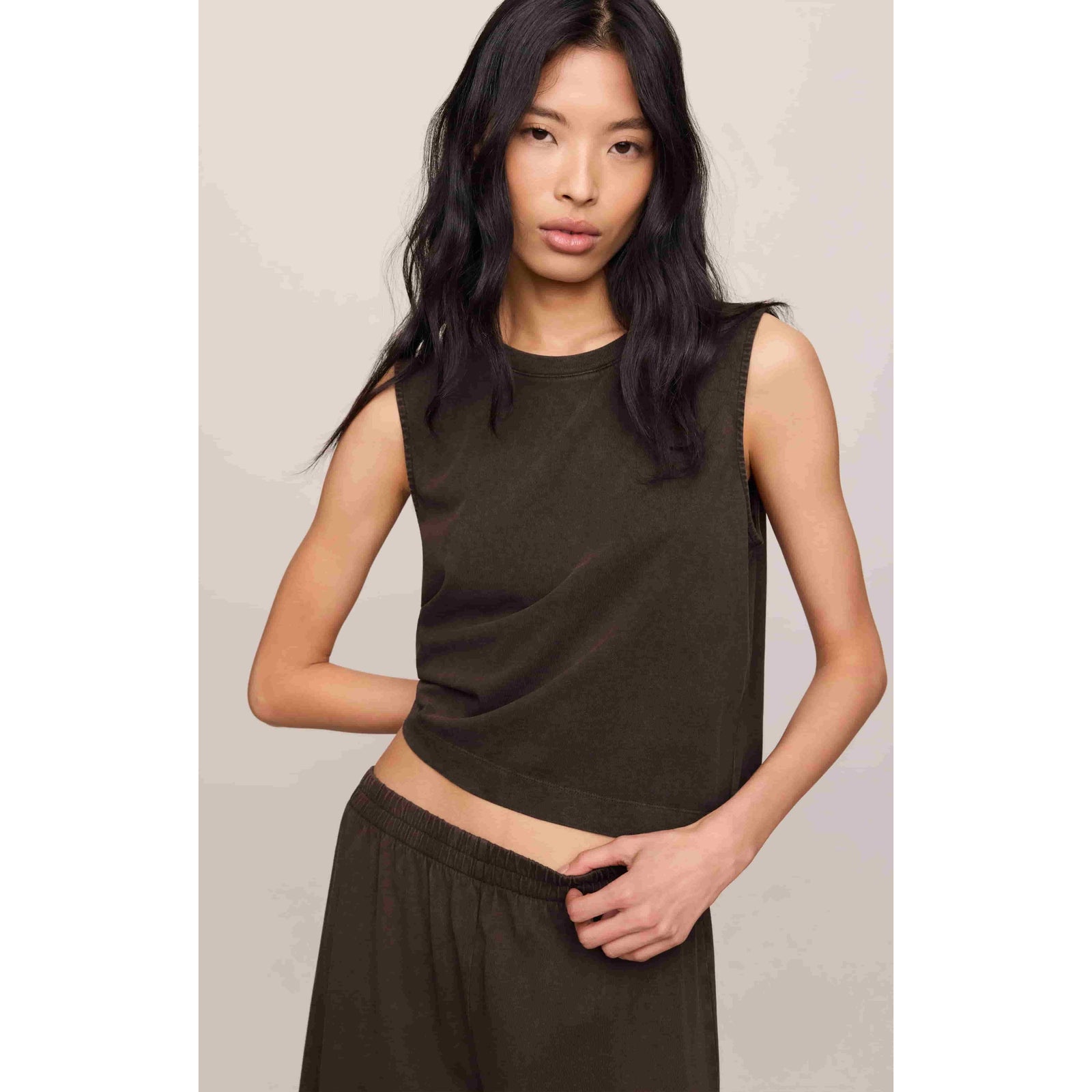 Model wearing Z Supply Sloane Muscle Jersey Tank in olive green, sleeveless crew neck, 100% cotton jersey.
