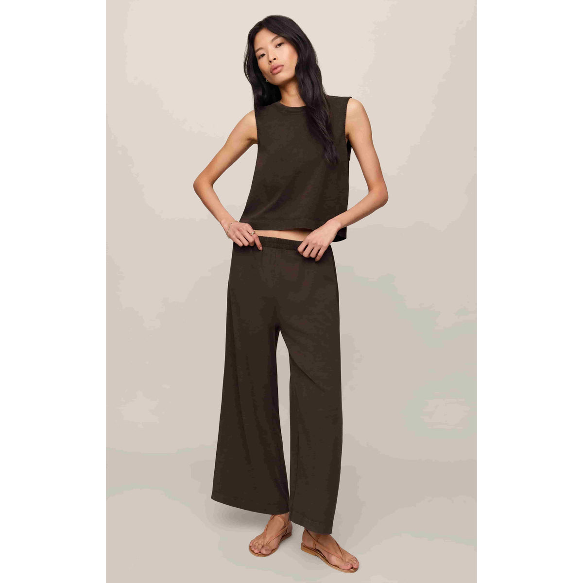 Model wearing Z Supply Sloane Muscle Jersey Tank in olive with matching wide-leg pants.