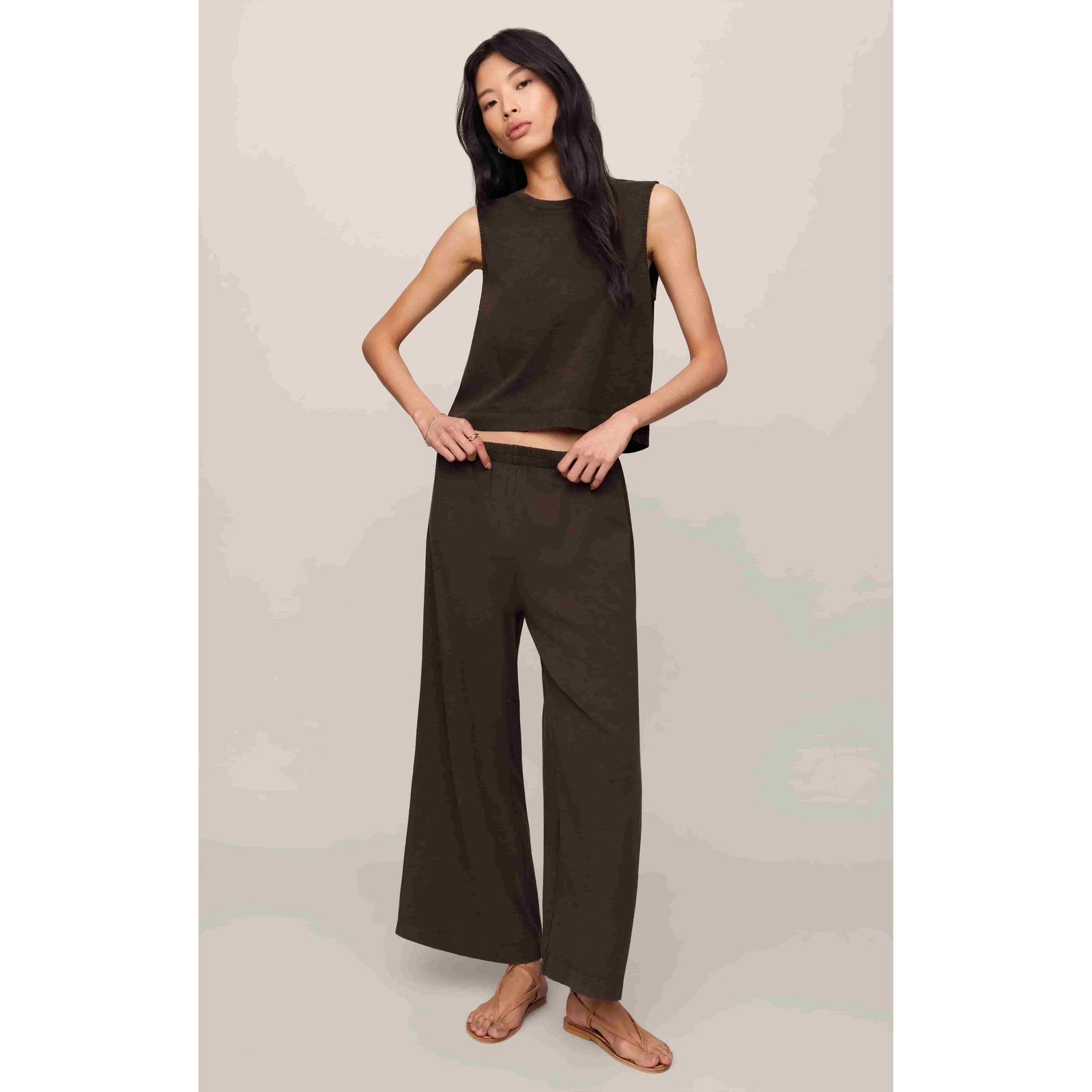 Model wearing Z Supply Sloane Muscle Jersey Tank in olive with matching wide-leg pants.