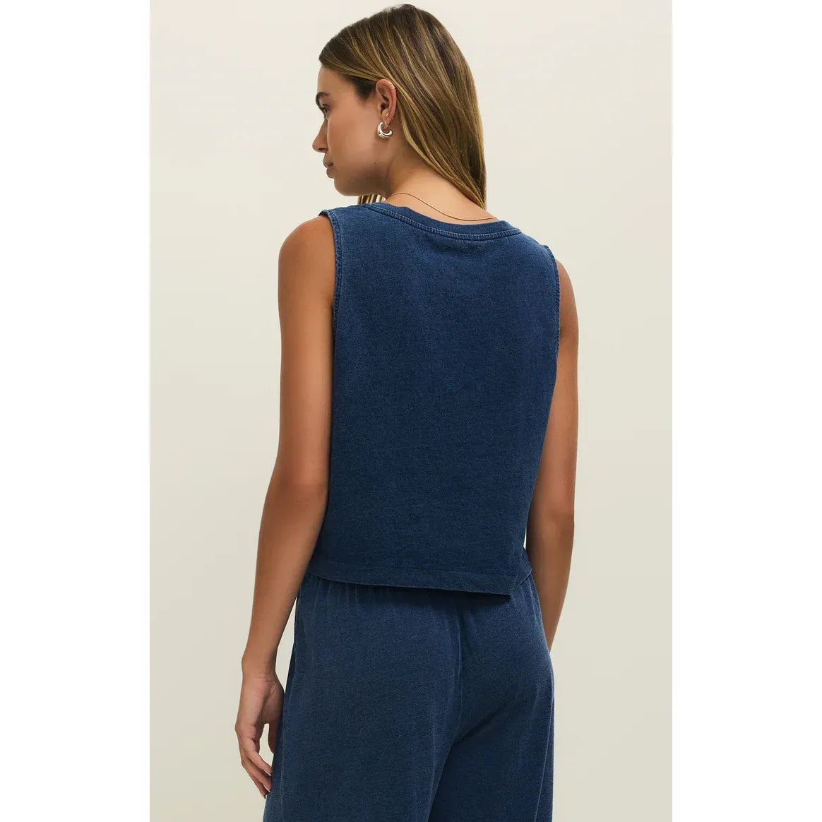 Back view of model wearing a navy blue Z Supply Sloane V-Neck Denim Tank, cropped sleeveless top.