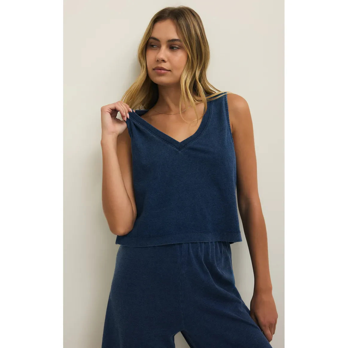Model wearing Z Supply Sloane V-Neck Denim Tank in light blue denim, relaxed fit.