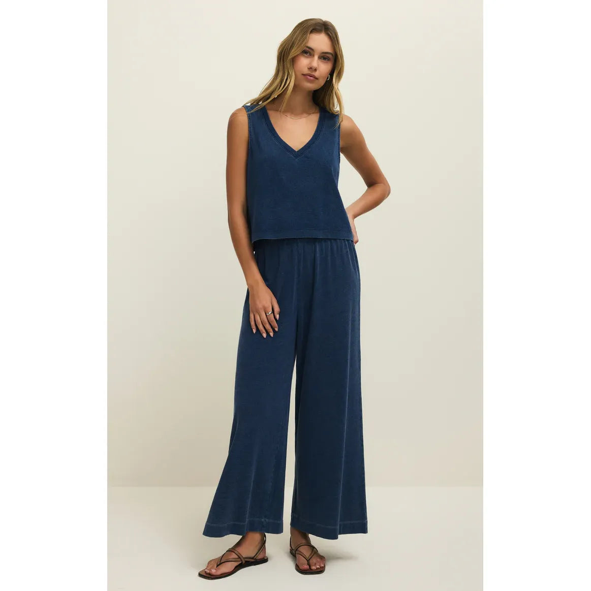 Z Supply Sloane V-Neck Denim Tank in blue on model; relaxed, sleeveless top with a V-neck.