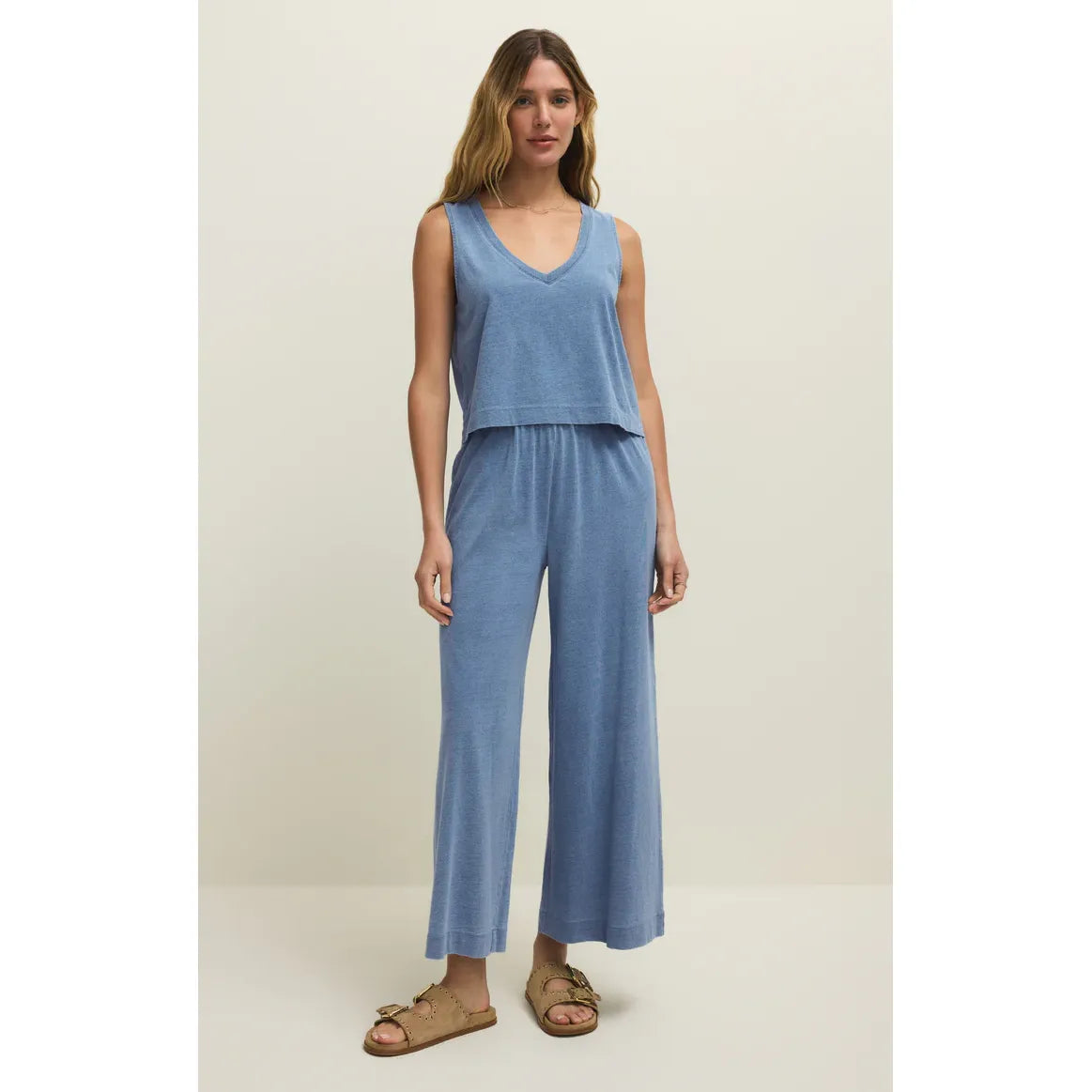 Z Supply Sloane V-Neck Denim Tank in blue on model, relaxed-fit sleeveless top for easy layering.