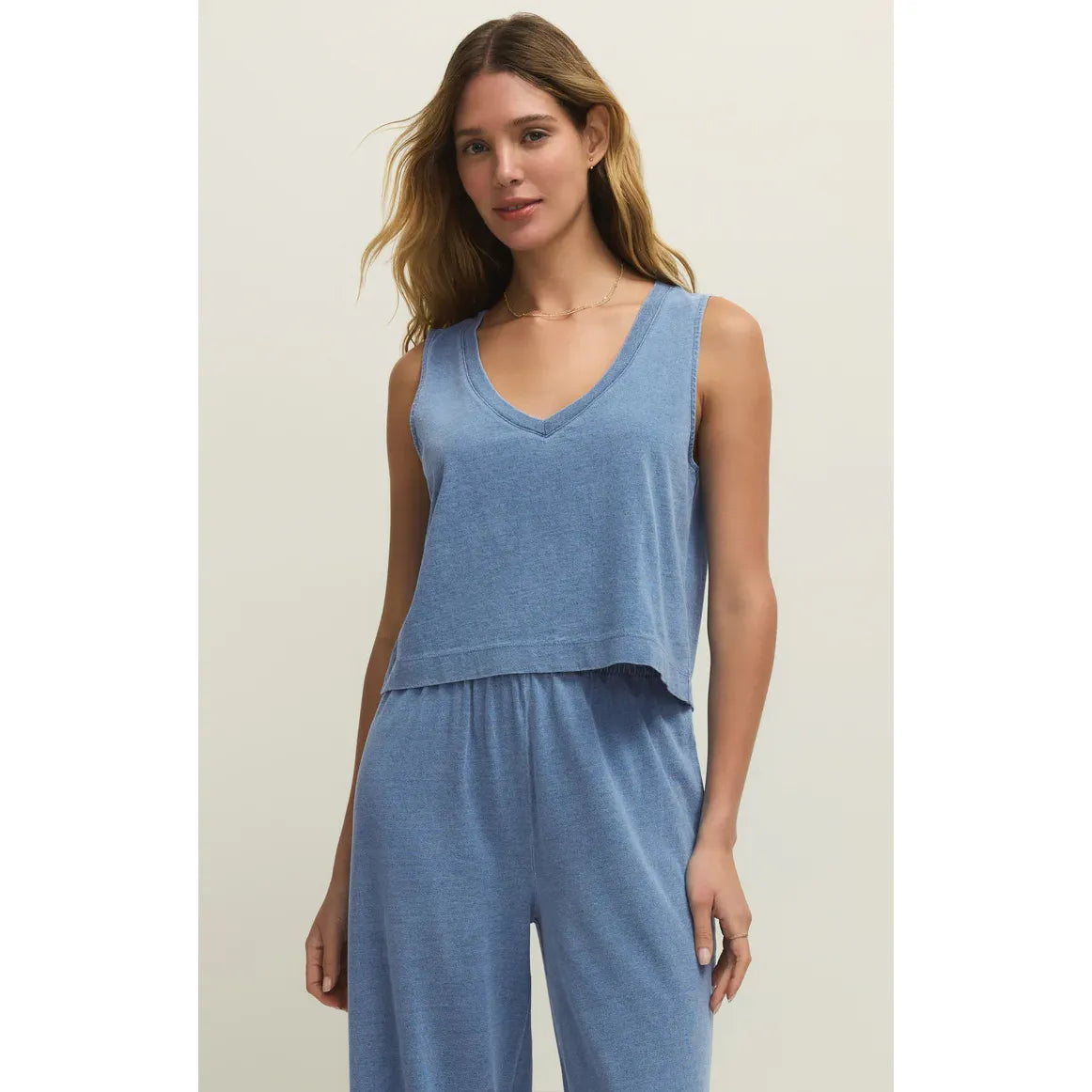 Model wearing Z Supply Sloane V-Neck Denim Tank in light blue denim, relaxed fit.