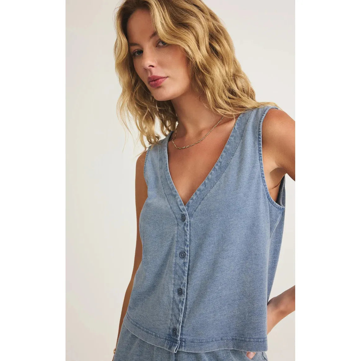 Stylish model wearing the Z Supply Solace V-Neck Jersey Denim Tank, perfect for vintage-inspired outfits.