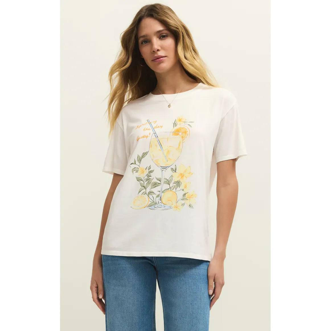 Model wearing Z Supply Spritz Boyfriend Tee in white with a citrus cocktail glass and yellow floral graphic.