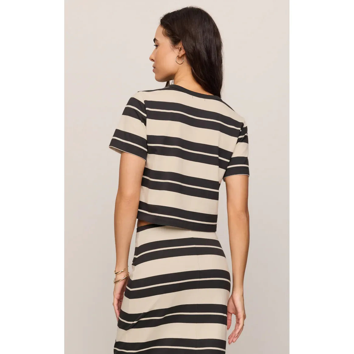 Back view of a beige and black striped cotton tee with cropped length from Z Supply Stellan Striped Tee.