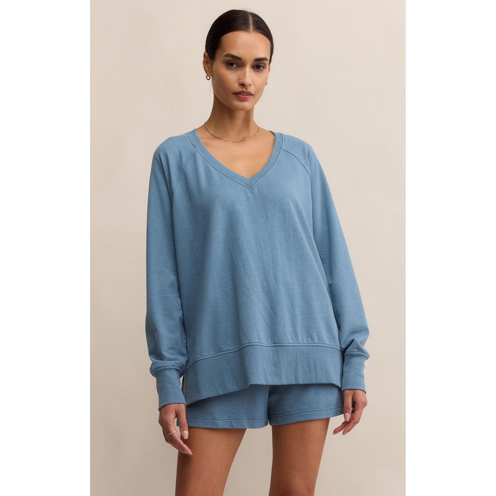 Z Supply blue oversized V-neck Weekender Top with long sleeves, side slits and hi-low hem; matching shorts.