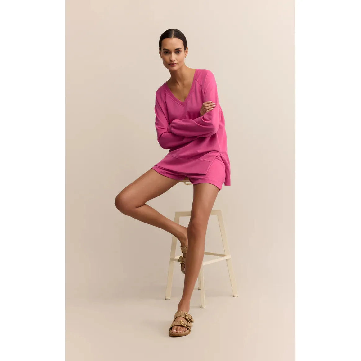 Model wearing pink Z Supply Modern V-Neck Weekender Top and matching shorts, oversized V-neck lounge set.