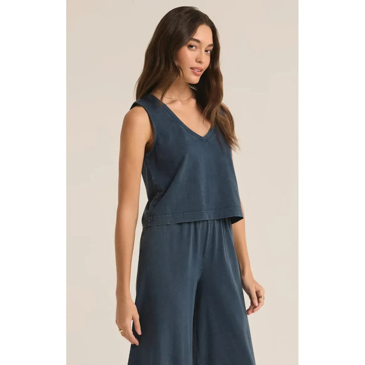 Stylish model wearing the Z Supply Sloane V-Neck Tank - Sale, featuring a relaxed fit and sleeveless design.