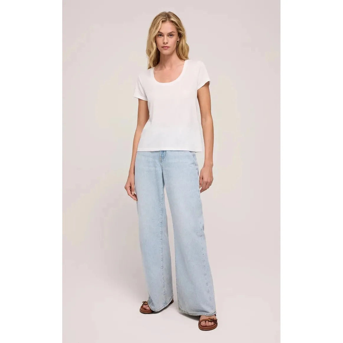 Stylish model wearing the Z Supply Anywhere Scoop Tee with relaxed jeans, showcasing its cozy and versatile design.