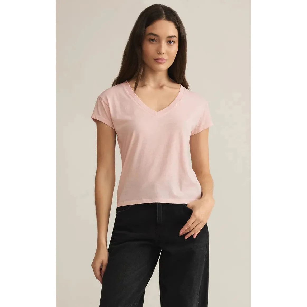 Stylish woman wearing the Z Supply Modern Jersey V-Neck Tee in pink, perfect for casual comfort and effortless style.
