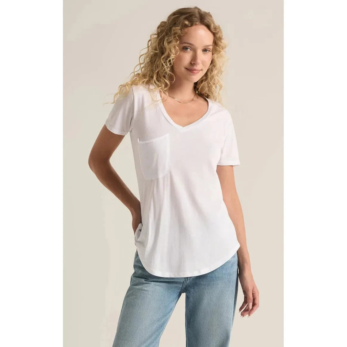 Stylish model wearing a Z Supply Pocket Tee in white, showcasing its flattering fit and versatile design.