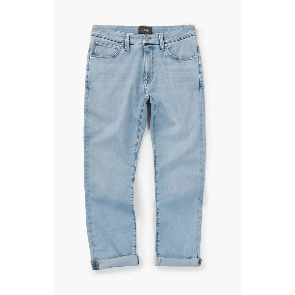 34 Heritage Courage straight-leg jeans in Bleached Urban with flexible stretch and rolled cuffs.