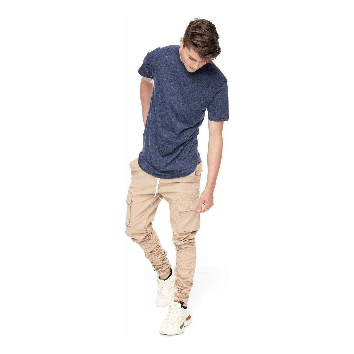 Kuwalla Scoop Tee navy on a model with tan cargo joggers; slim, double‑stitched scooped hem.