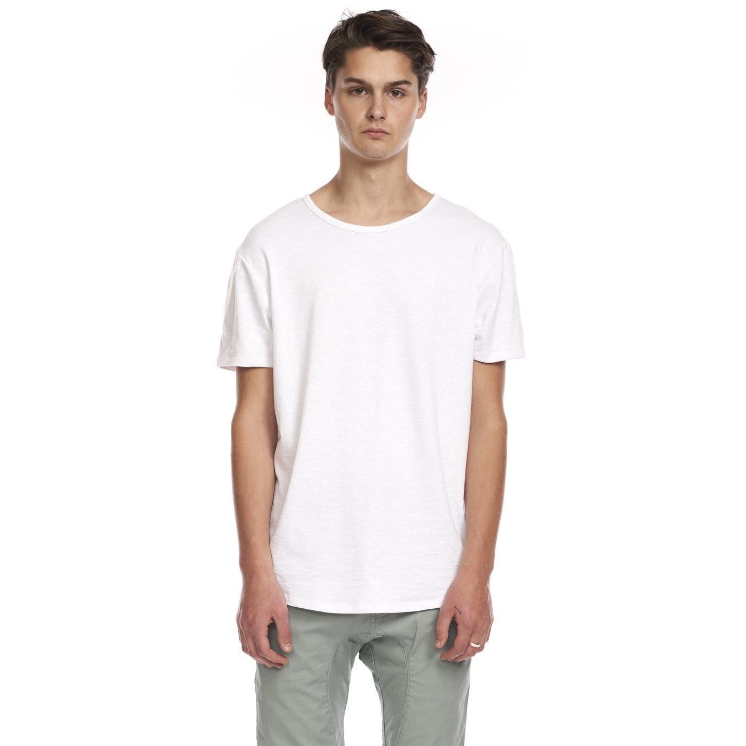 Kuwalla Slub Hi-Lo Tee on male model; white quad-blended tee with curved hi-lo hem, slub fabric, center-back hem label.