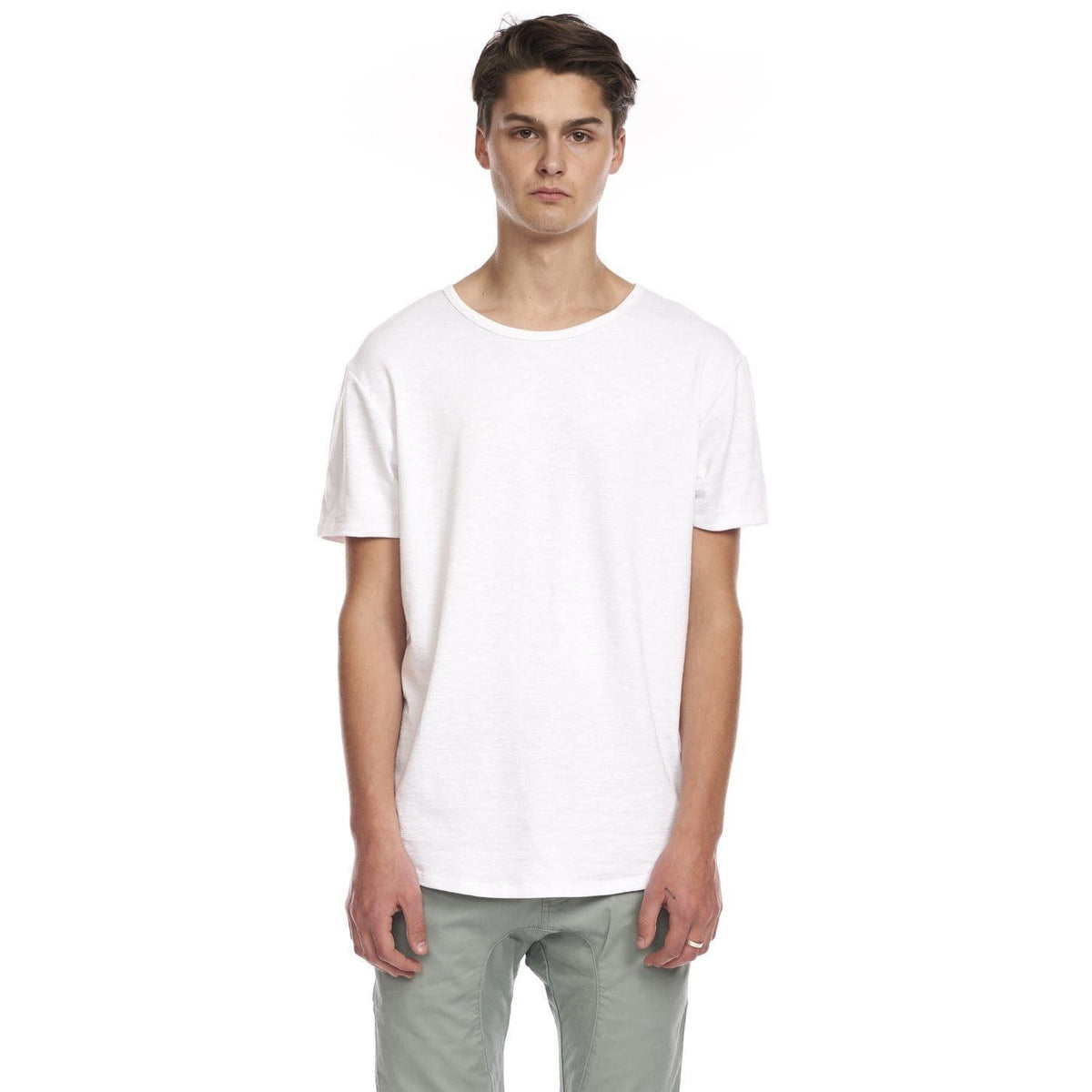 Kuwalla Slub Hi-Lo Tee on male model; white quad-blended tee with curved hi-lo hem, slub fabric, center-back hem label.