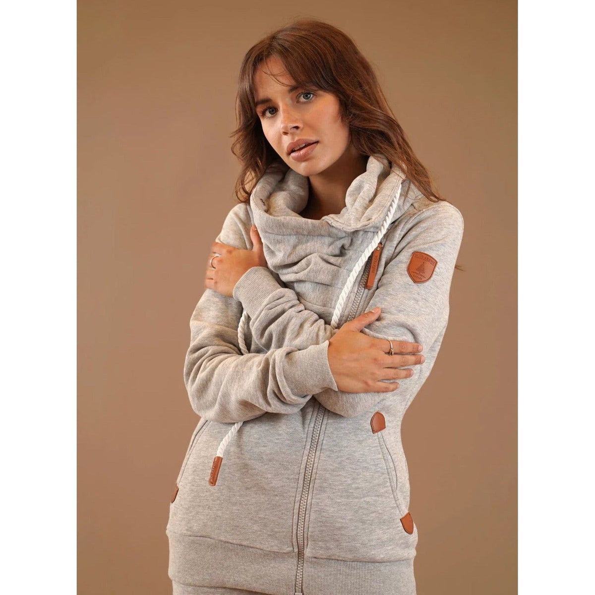 Wanakome Hestia Zip Up in light grey, featuring a cozy funnel neck and asymmetrical zipper for a flattering fit.