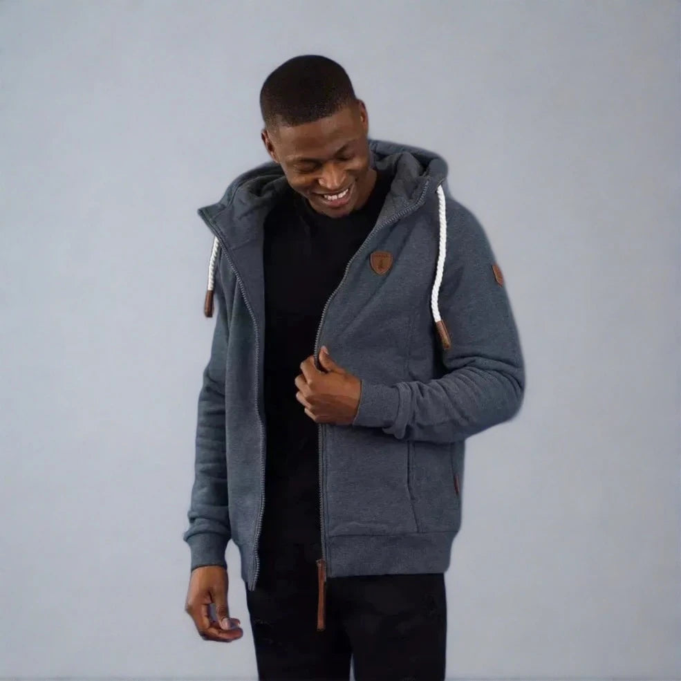 Wanakome Zeus Hoodie in navy worn by a man, zip front with white rope drawstrings and leather accents.